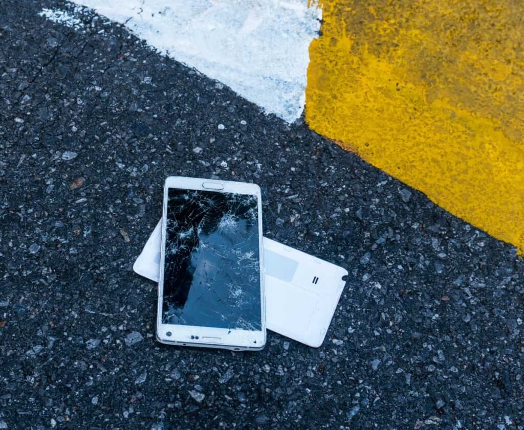 broken-phone-on-asphalt