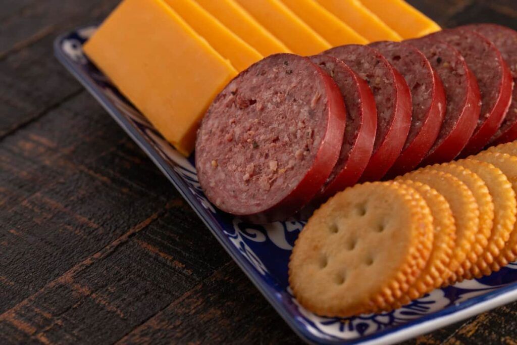 summer sausage alongside cheddar cheese and butter crackers